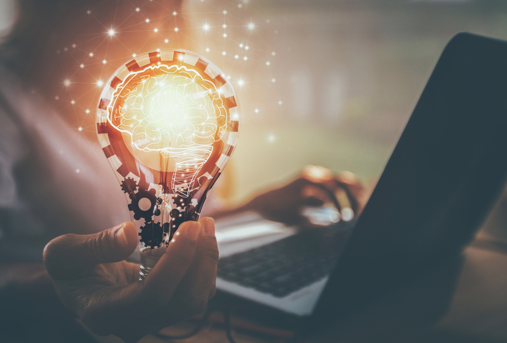 Business,Women,Hand,Holding,Light,Bulb,,Concept,Of,New,Ideas