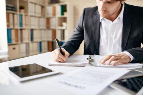 Male,Employee,Writing,Business,Plan,At,Workplace